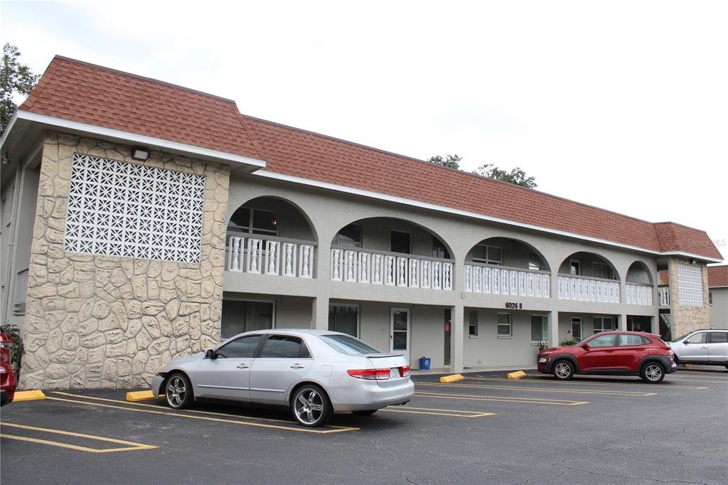 a front view of a building with parking
