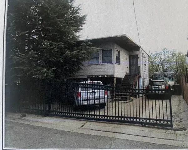 a front view of a house with a fence