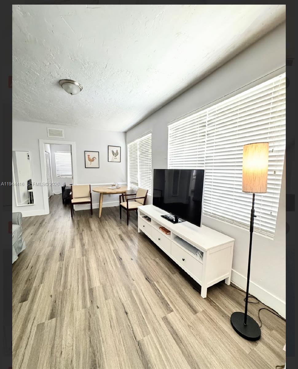 1821 Northwest 33rd Street Miami, FL 33142 - Photo 13 of 18 a living room with furniture and a flat screen tv