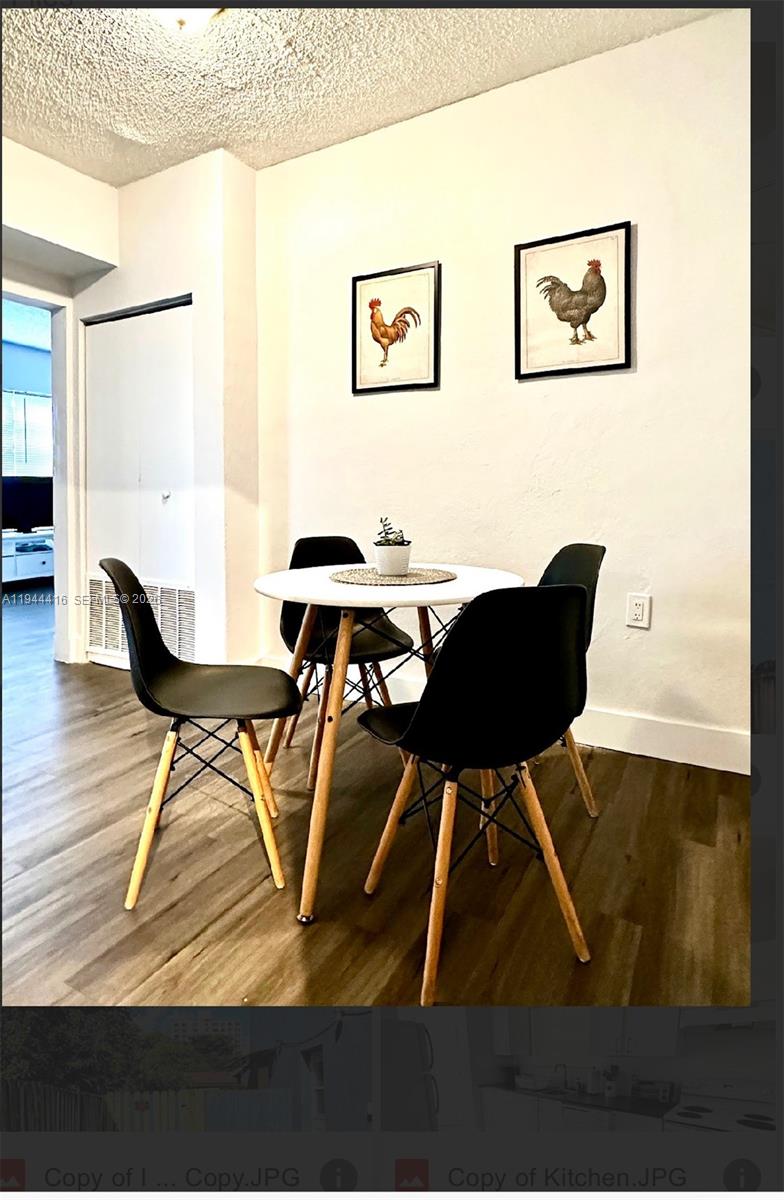 1821 Northwest 33rd Street Miami, FL 33142 - Photo 3 of 18 a view of a dining room with furniture and wooden floor