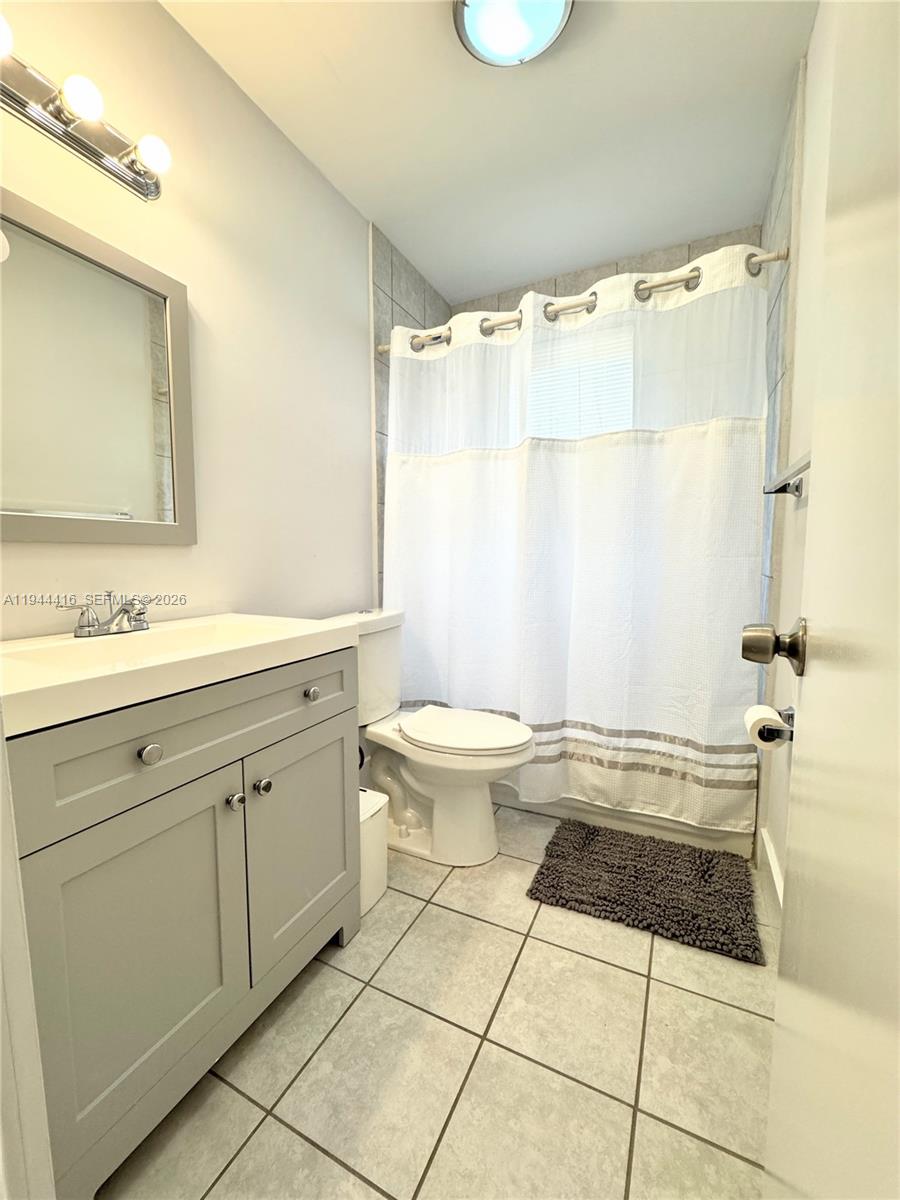 1821 Northwest 33rd Street Miami, FL 33142 - Photo 10 of 18 a bathroom with a sink toilet and shower