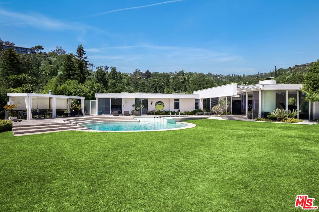 1012 Wallace Ridge Beverly Hills, CA 90210 - Photo 31 of 41 a front view of a house with a garden