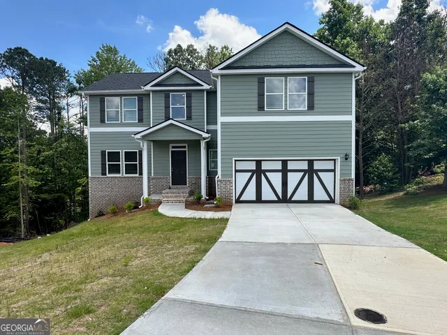 a front view of a house with yard