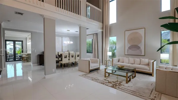 a living room with furniture and a dining table