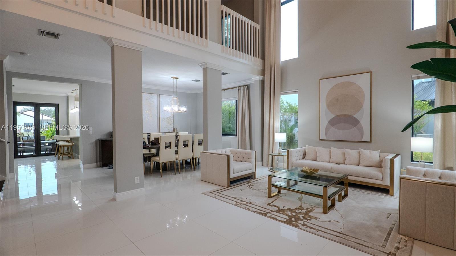 a living room with furniture and a dining table