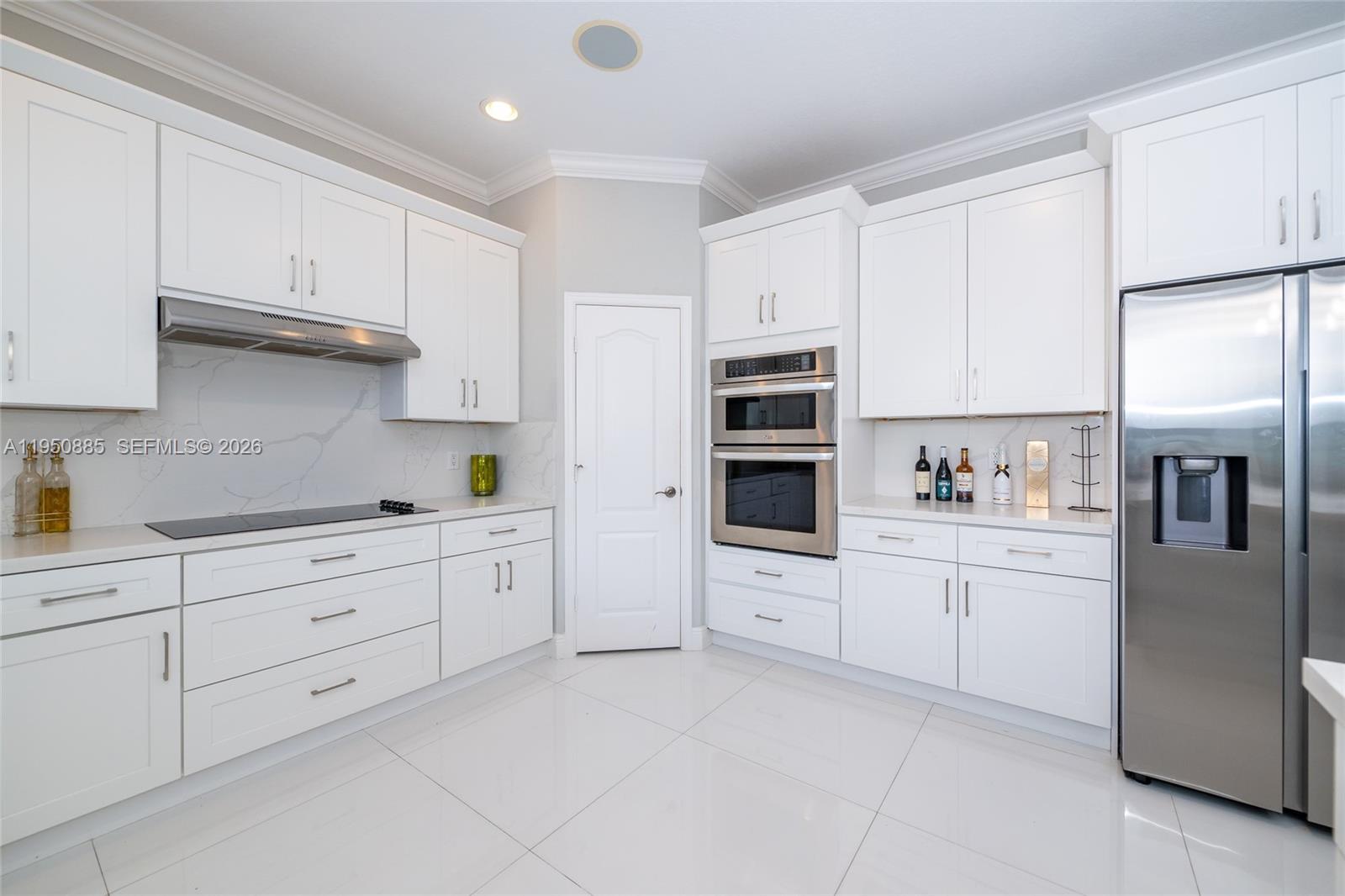 18540 Southwest 43rd Street Miramar, FL 33029 - Photo 12 of 56 a kitchen with white cabinets and white appliances