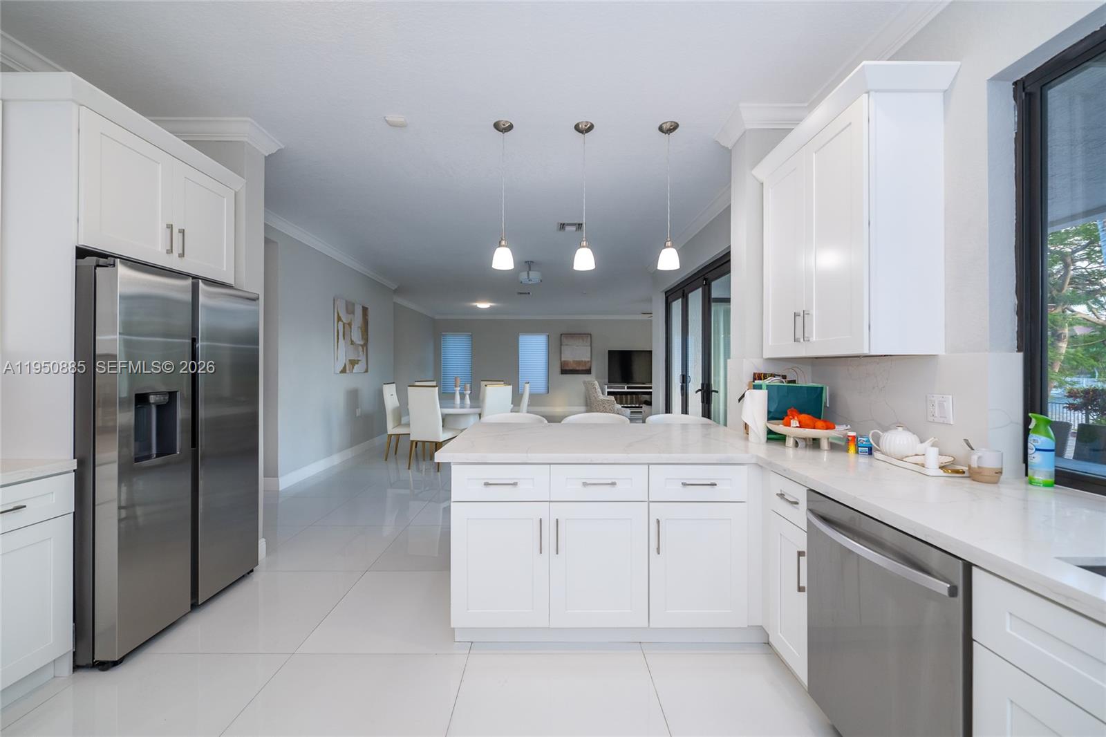 18540 Southwest 43rd Street Miramar, FL 33029 - Photo 15 of 56 a kitchen with a sink window and stainless steel appliances