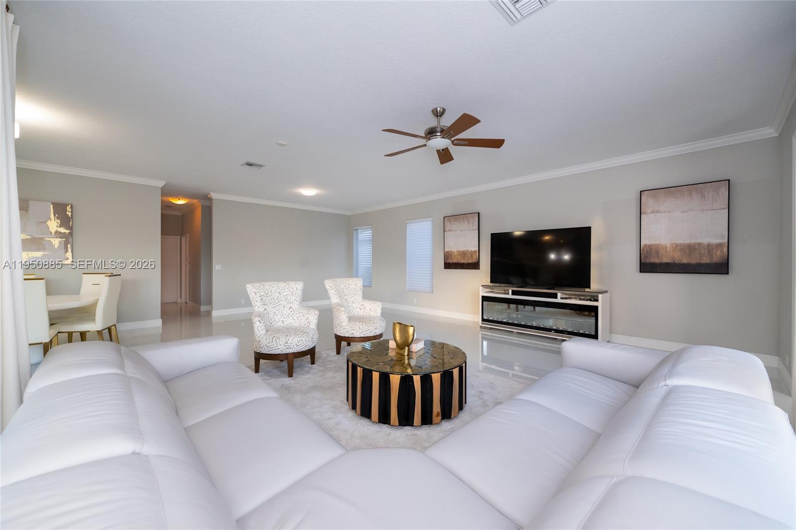 18540 Southwest 43rd Street Miramar, FL 33029 - Photo 18 of 56 a living room with furniture a flat screen tv and a window