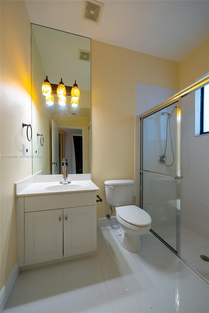 18540 Southwest 43rd Street Miramar, FL 33029 - Photo 19 of 56 a bathroom with a toilet sink and mirror