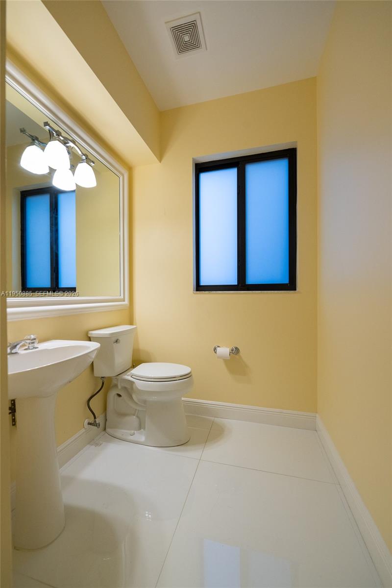 18540 Southwest 43rd Street Miramar, FL 33029 - Photo 20 of 56 a bathroom with a sink a toilet and mirror
