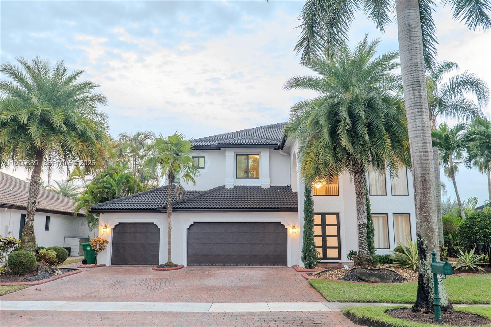 18540 Southwest 43rd Street Miramar, FL 33029 - Photo 2 of 56 a view of a house with a yard and palm trees