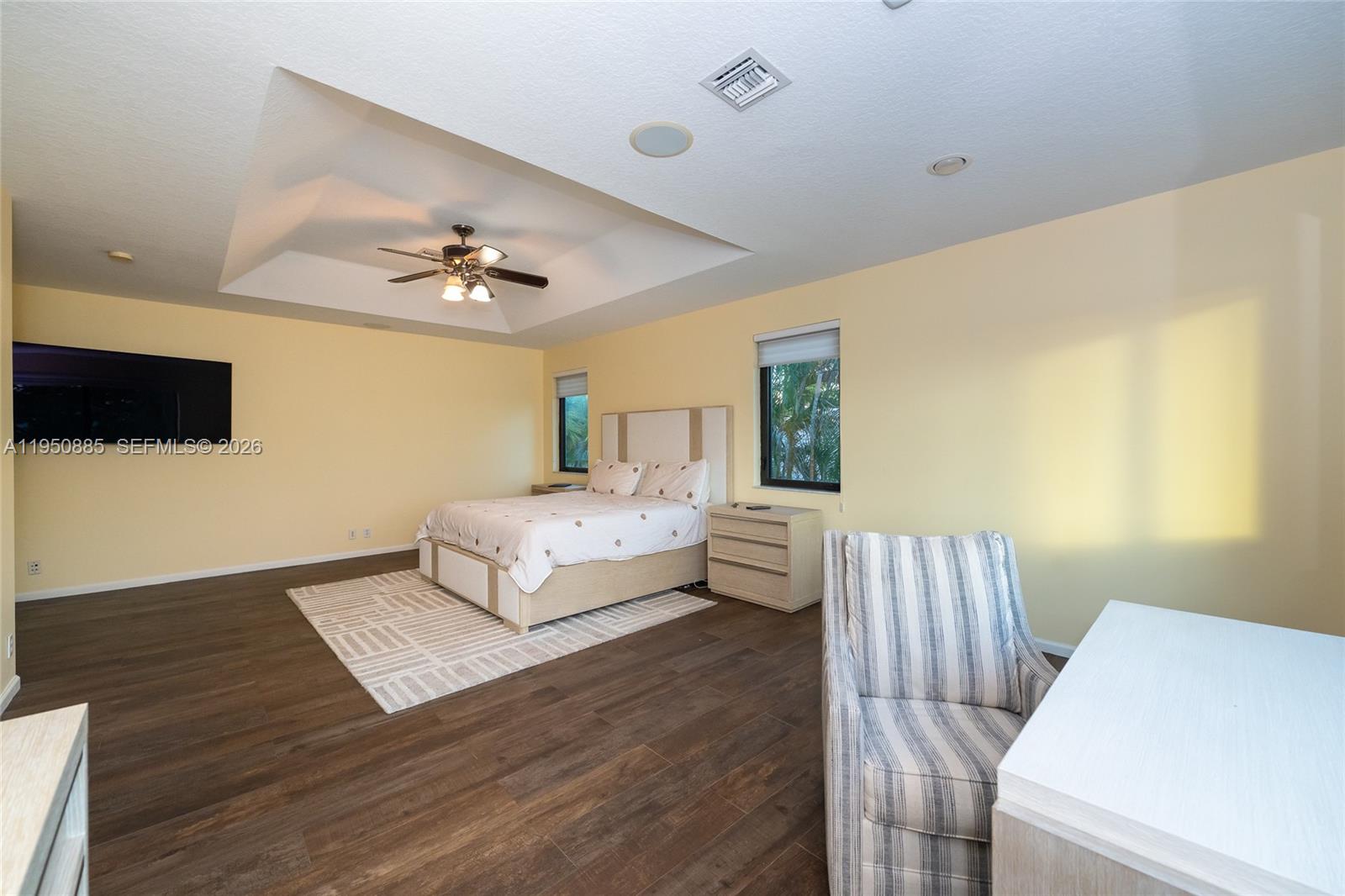 18540 Southwest 43rd Street Miramar, FL 33029 - Photo 26 of 56 a bedroom with a bed and a flat screen tv
