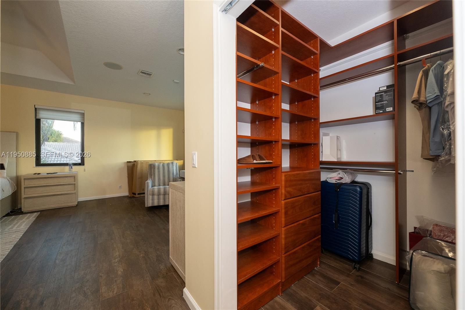18540 Southwest 43rd Street Miramar, FL 33029 - Photo 30 of 56 a view of walk in closet with clothes and shoes