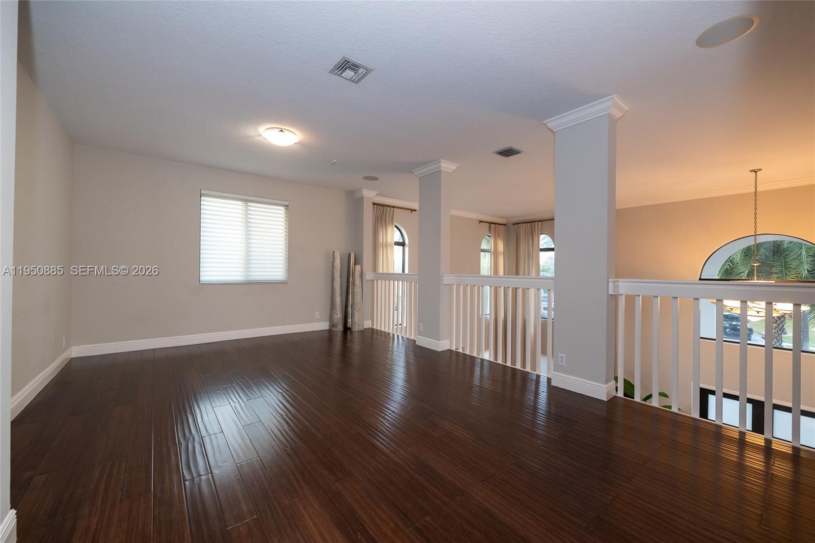 18540 Southwest 43rd Street Miramar, FL 33029 - Photo 31 of 56 a view of an empty room with wooden floor and a window