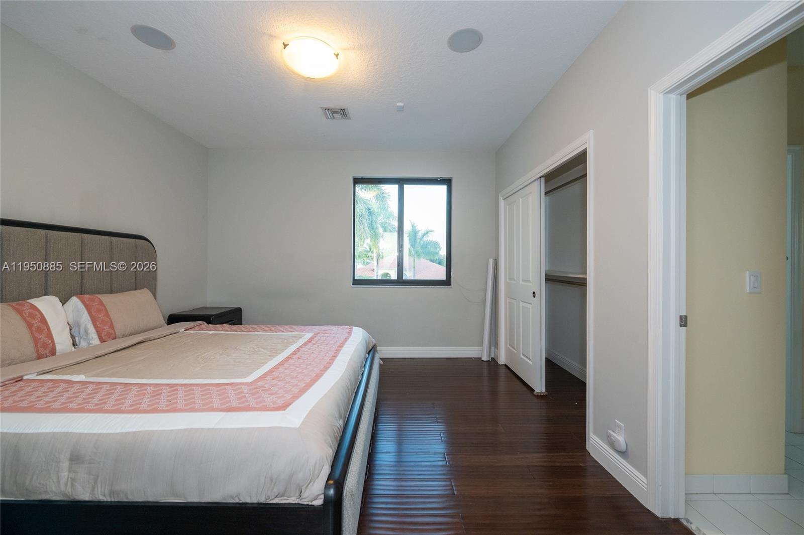 18540 Southwest 43rd Street Miramar, FL 33029 - Photo 35 of 56 a bedroom with a bed and wooden floor