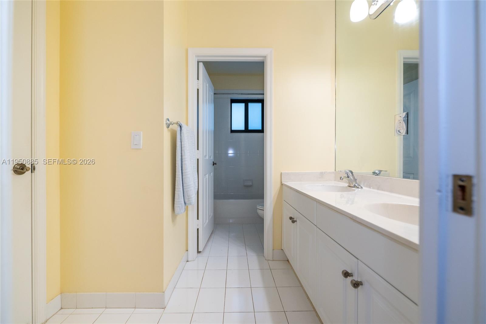 18540 Southwest 43rd Street Miramar, FL 33029 - Photo 36 of 56 a spacious bathroom with a double vanity sink a mirror and a bathtub