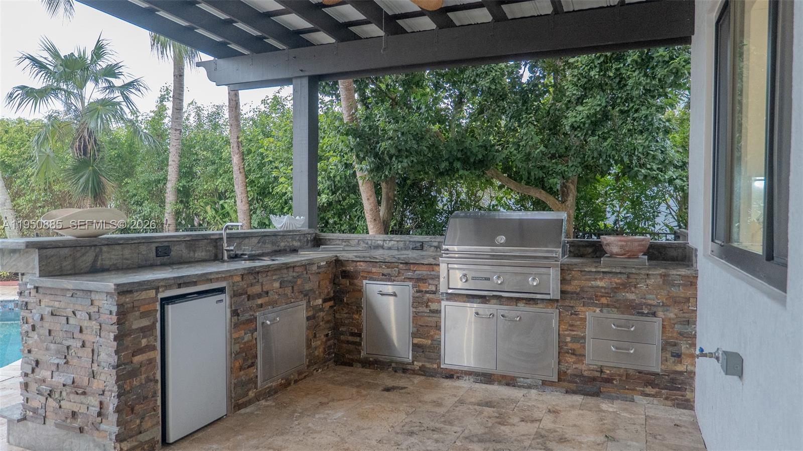 18540 Southwest 43rd Street Miramar, FL 33029 - Photo 45 of 56 a kitchen with a stove and a sink