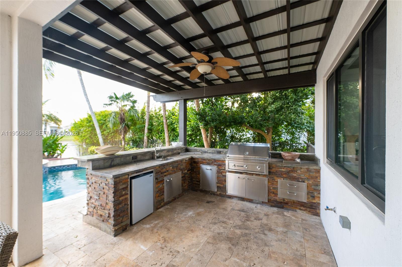 18540 Southwest 43rd Street Miramar, FL 33029 - Photo 48 of 56 a large kitchen with kitchen island a large window in it