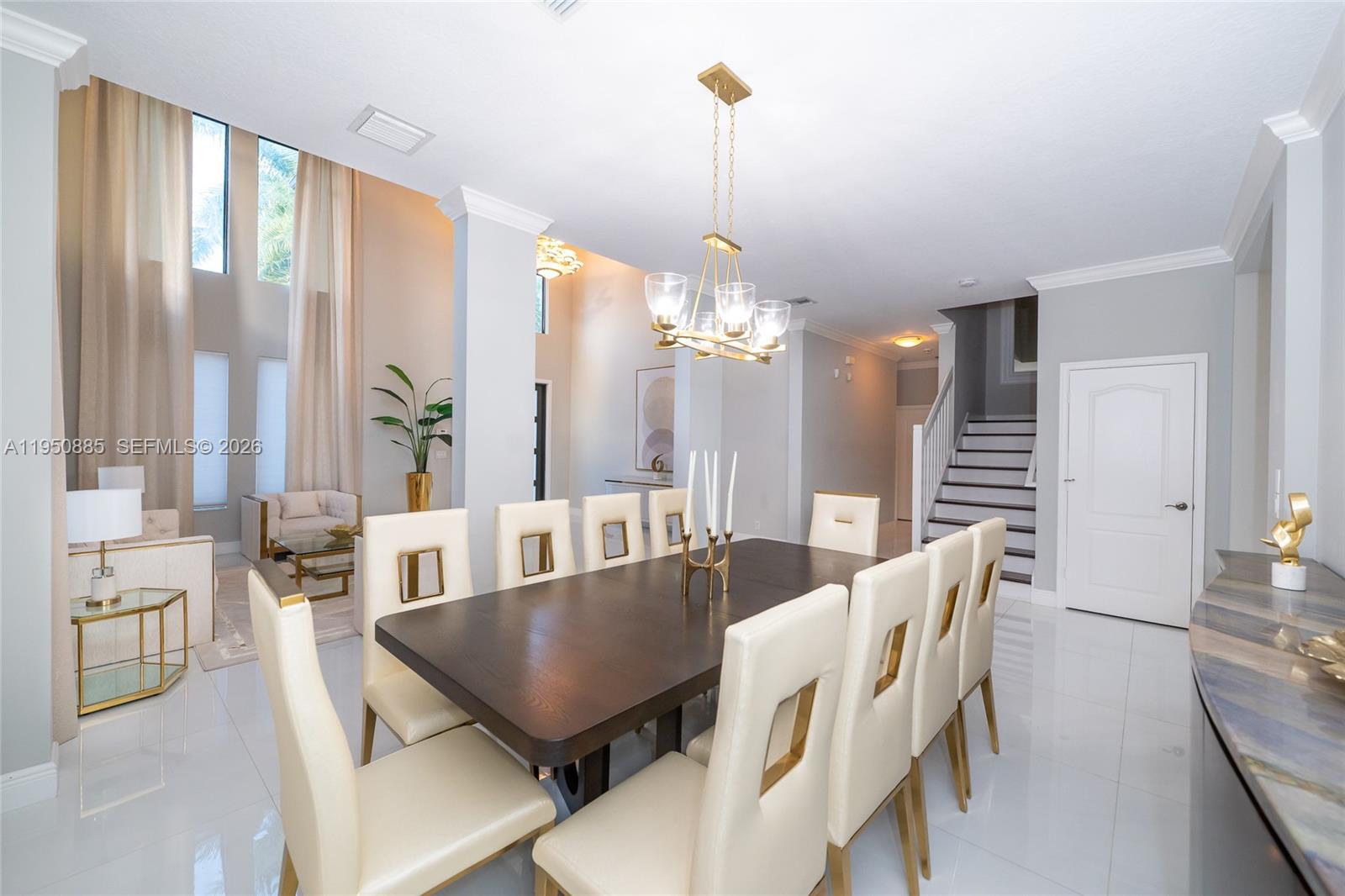 18540 Southwest 43rd Street Miramar, FL 33029 - Photo 7 of 56 a view of a dining room with furniture a chandelier and wooden floor