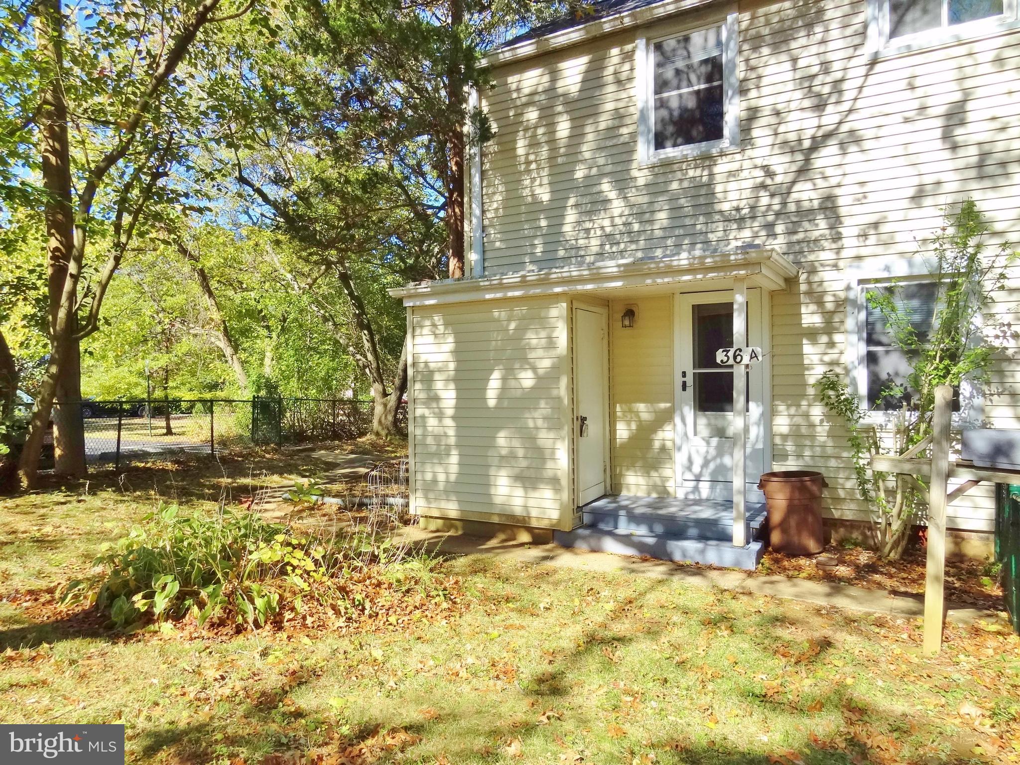 36 Ridge Road, Unit A Greenbelt, MD 20770 - Photo 6 of 14 Fenced front yard with service-side addition