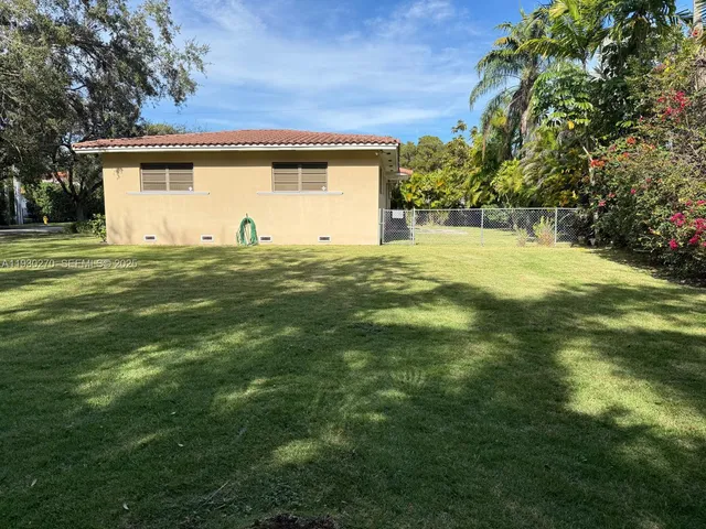 a view of a backyard with large trees