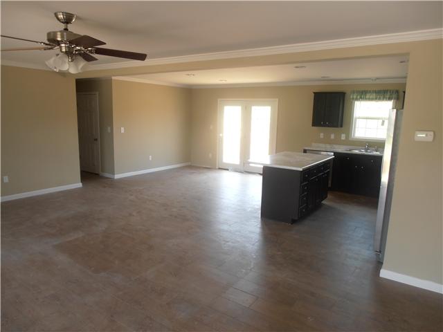 1147 Wrights Mill Road Spring Hill, TN 37174 - Photo 10 of 12 Very spacious open floor plan. Upgraded laminate flooring, crown molding through out, kitchen with and island, french doors opening up to the back deck, modern kitchen cabinets and formica counters and upgraded stainless steel appliances!