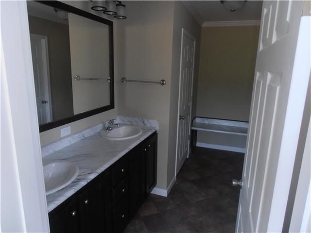 1147 Wrights Mill Road Spring Hill, TN 37174 - Photo 4 of 12 Master bath 1 with double vanities and a bench seating area in the back.