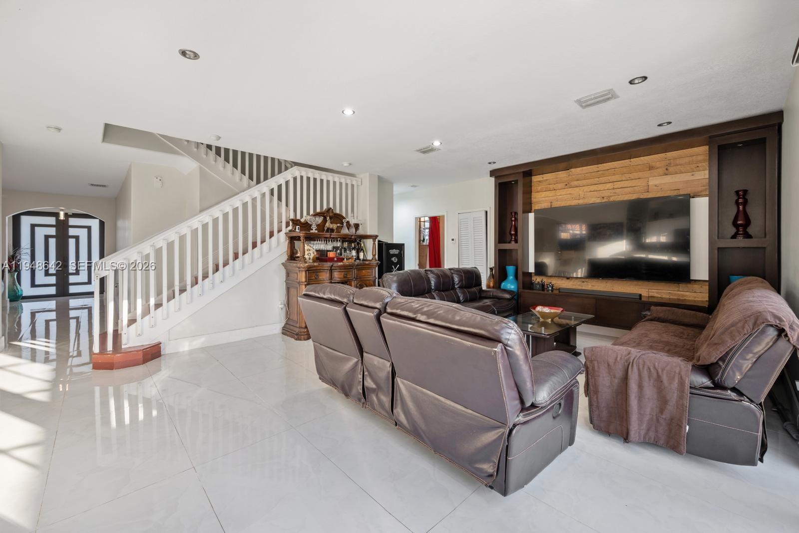 1360 Southwest 142nd Avenue Miami, FL 33184 - Photo 15 of 54 a living room with furniture and a flat screen tv