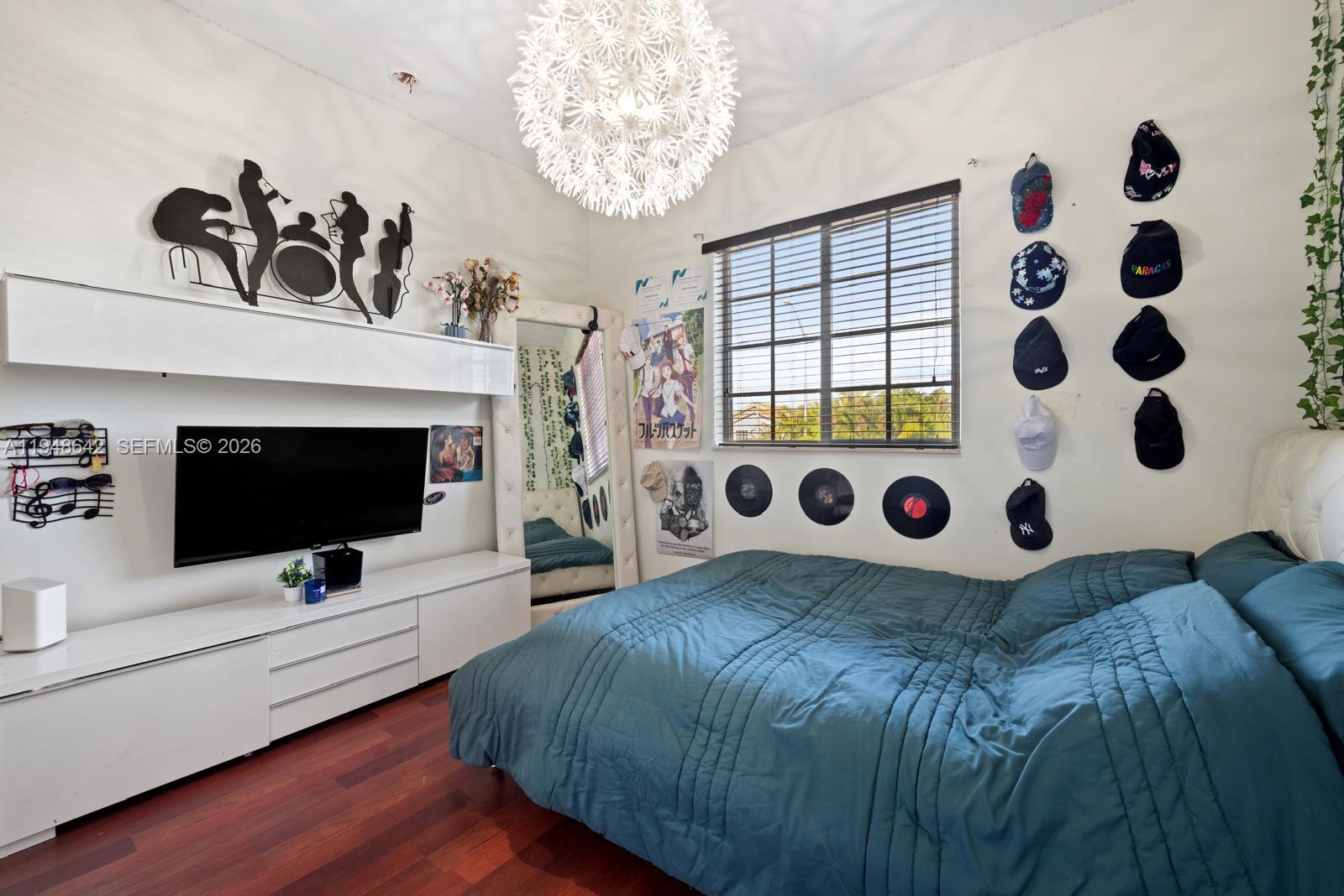 1360 Southwest 142nd Avenue Miami, FL 33184 - Photo 19 of 54 a bedroom with a bed and a flat screen tv