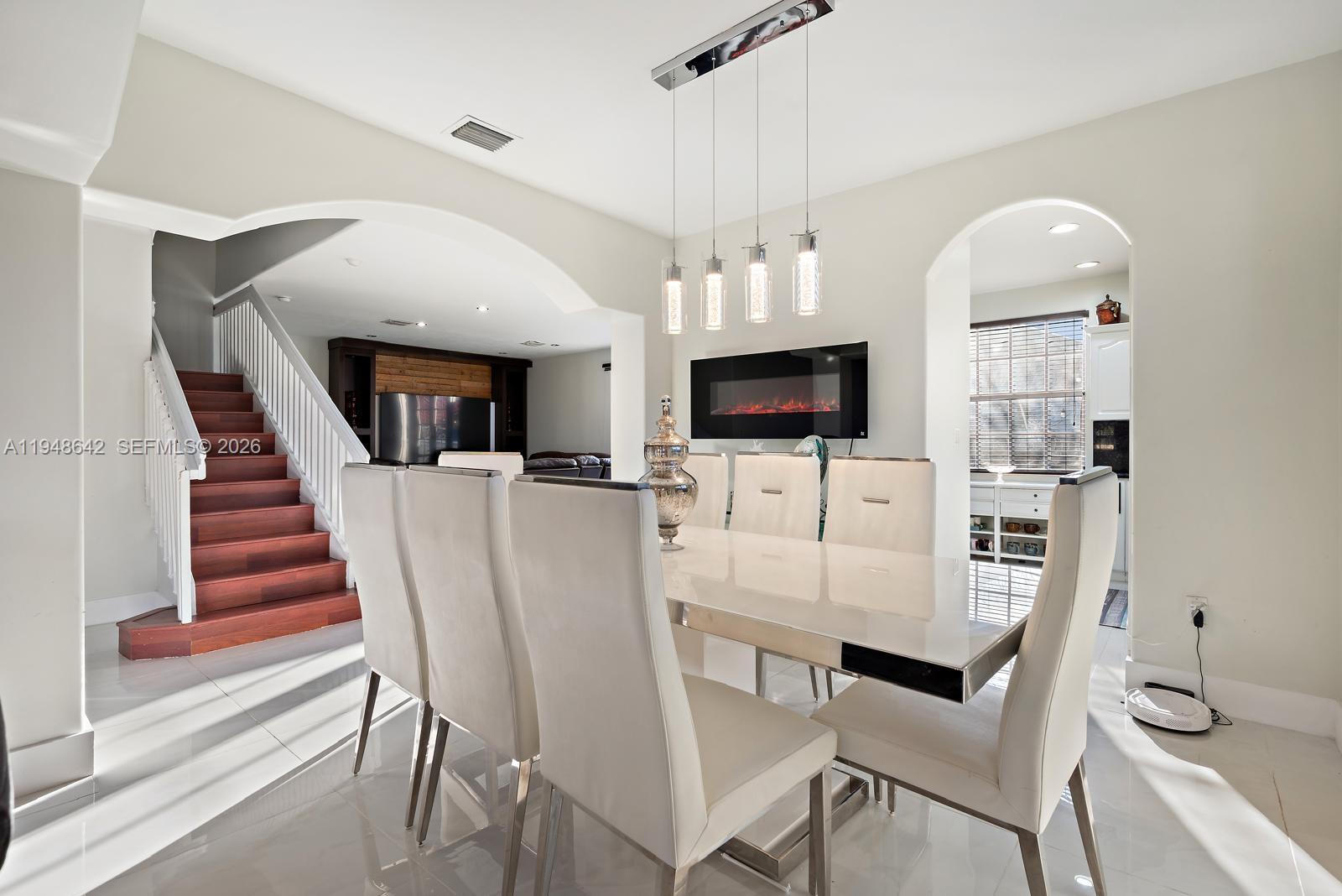 1360 Southwest 142nd Avenue Miami, FL 33184 - Photo 20 of 54 a living room with furniture a fireplace and a flat screen tv