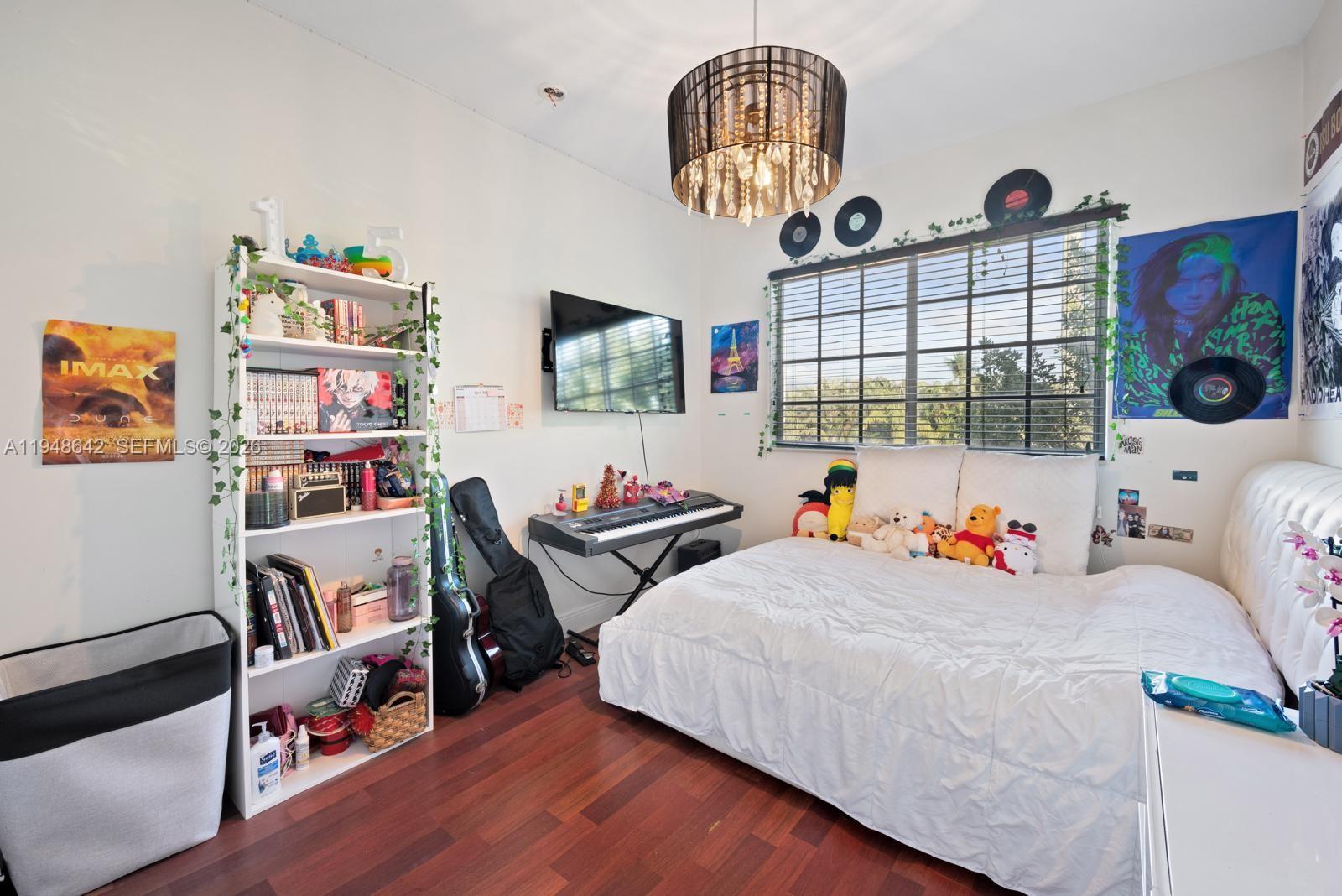 1360 Southwest 142nd Avenue Miami, FL 33184 - Photo 21 of 54 a bedroom with furniture and a flat screen tv