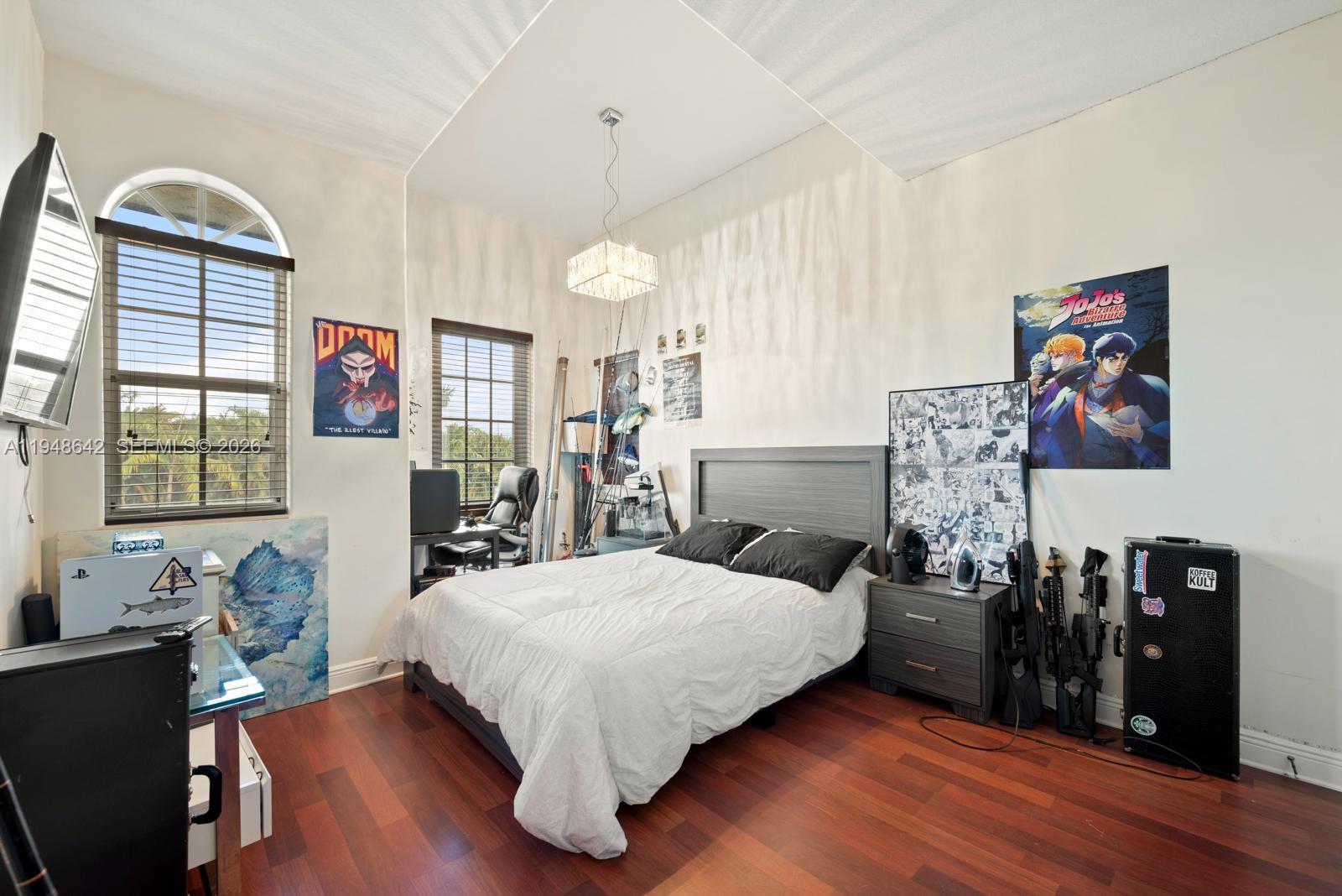 1360 Southwest 142nd Avenue Miami, FL 33184 - Photo 23 of 54 a bedroom with a bed and wooden floor