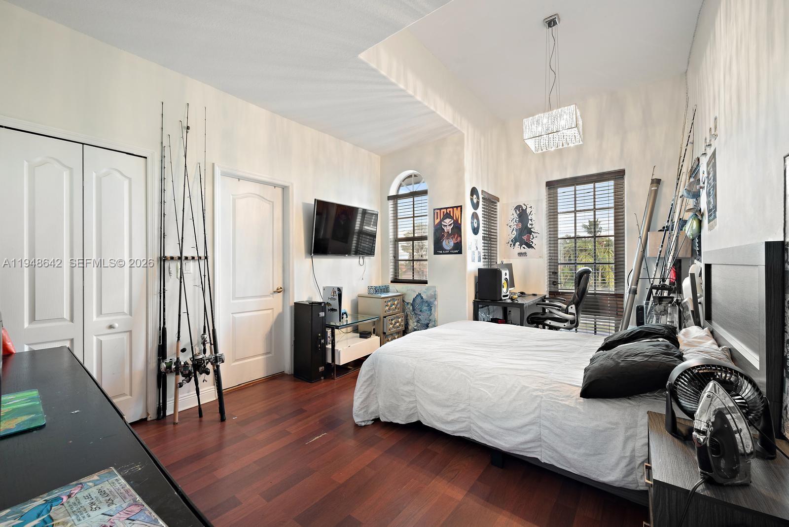 1360 Southwest 142nd Avenue Miami, FL 33184 - Photo 25 of 54 a bedroom with a bed couch and a flat tv screen