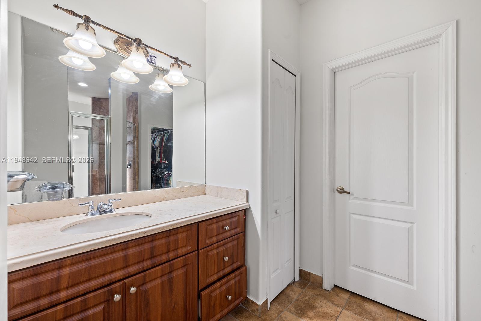 1360 Southwest 142nd Avenue Miami, FL 33184 - Photo 26 of 54 a bathroom with a double vanity sink and mirror