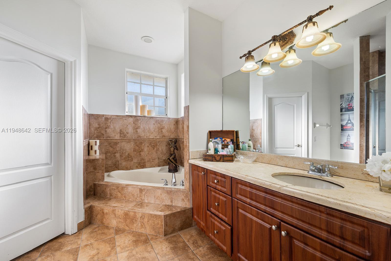1360 Southwest 142nd Avenue Miami, FL 33184 - Photo 27 of 54 a bathroom with a granite countertop sink mirror and bathtub