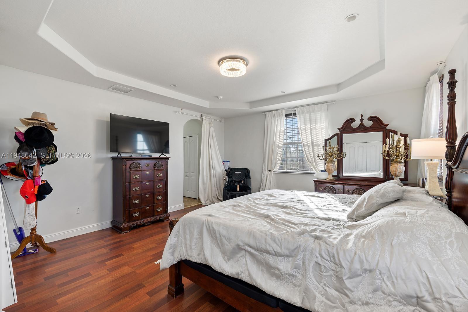 1360 Southwest 142nd Avenue Miami, FL 33184 - Photo 28 of 54 a bedroom with a bed and a flat tv screen on dresser