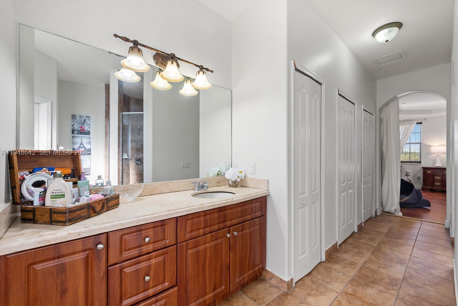 1360 Southwest 142nd Avenue Miami, FL 33184 - Photo 33 of 54 a bathroom with a double vanity sink and a mirror