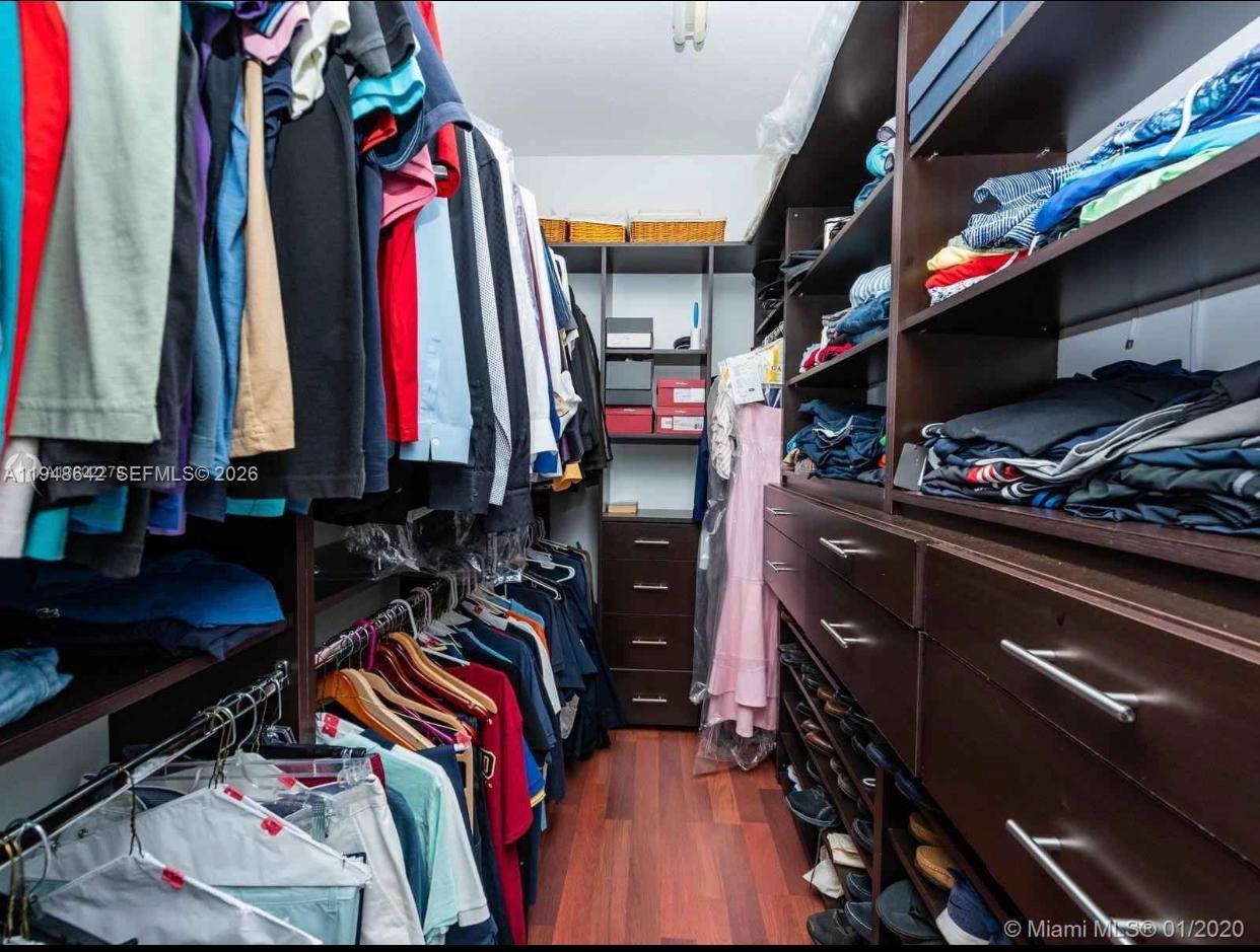 1360 Southwest 142nd Avenue Miami, FL 33184 - Photo 45 of 54 a view of walk in closet with clothes and shoes