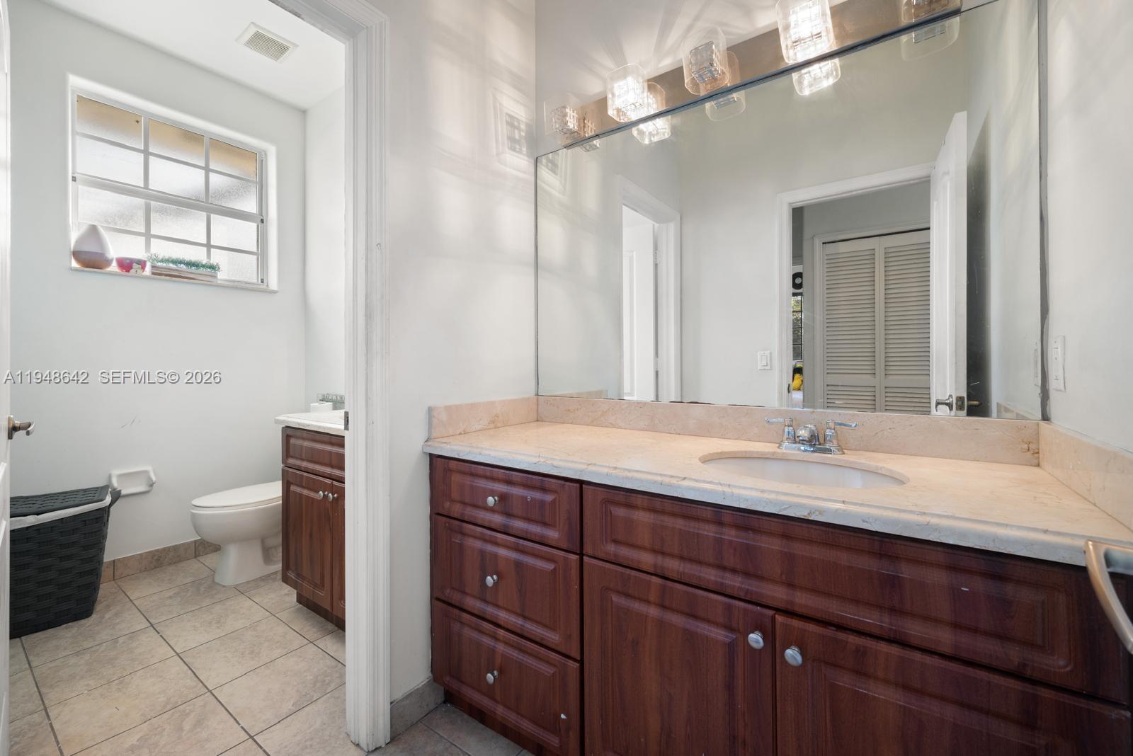 1360 Southwest 142nd Avenue Miami, FL 33184 - Photo 48 of 54 a bathroom with a granite countertop sink toilet and mirror
