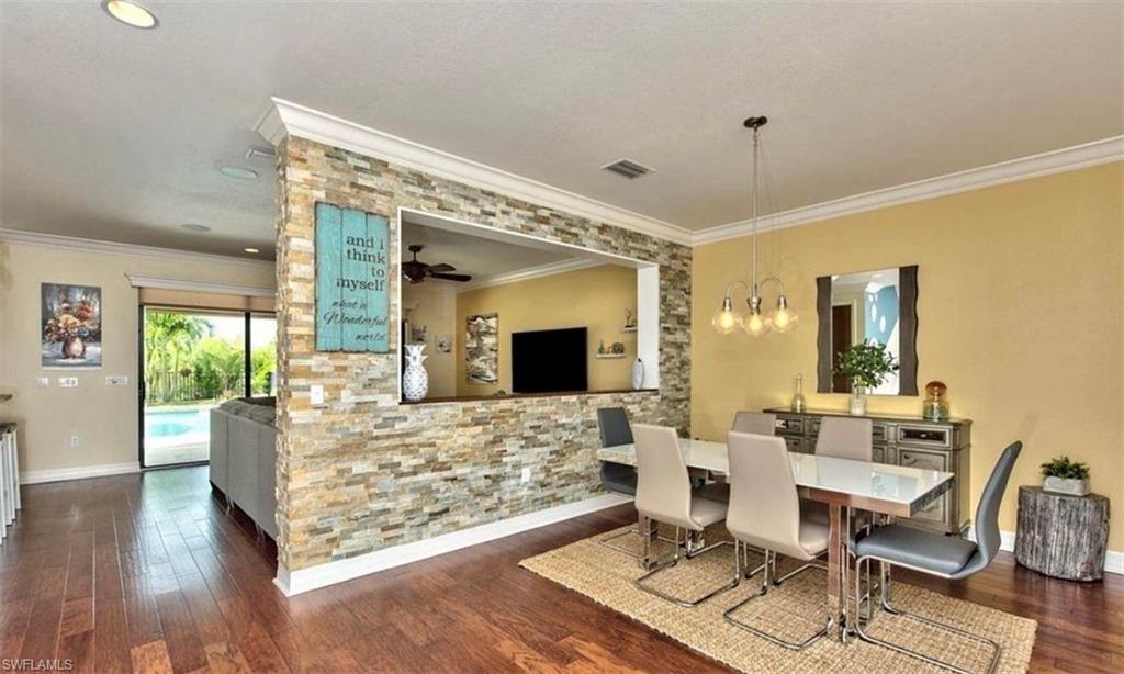 3402 Tigris Lane Naples, FL 34119 - Photo 15 of 50 a living room with furniture and a flat screen tv