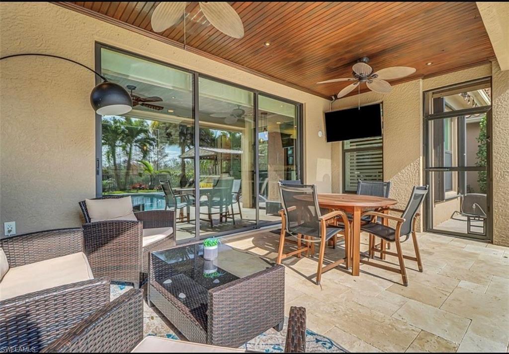 3402 Tigris Lane Naples, FL 34119 - Photo 18 of 50 a outdoor space with patio the couches and a dining table with garden view