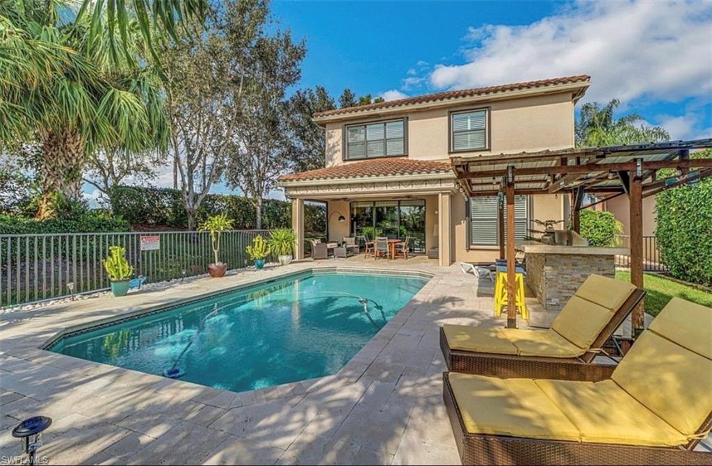 3402 Tigris Lane Naples, FL 34119 - Photo 19 of 50 a view of a house with pool