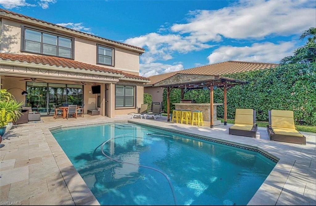 3402 Tigris Lane Naples, FL 34119 - Photo 2 of 50 a view of a patio with swimming pool table and chairs