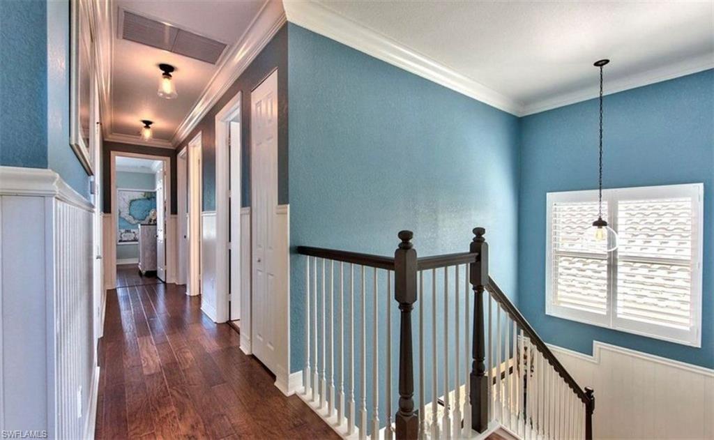3402 Tigris Lane Naples, FL 34119 - Photo 24 of 50 a view of a hallway with wooden floor and staircase