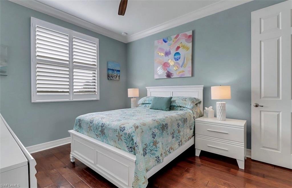 3402 Tigris Lane Naples, FL 34119 - Photo 28 of 50 a bedroom with a bed and a painting on the wall