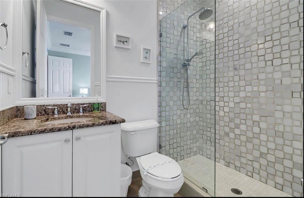 3402 Tigris Lane Naples, FL 34119 - Photo 29 of 50 a bathroom with a granite countertop sink a toilet and shower