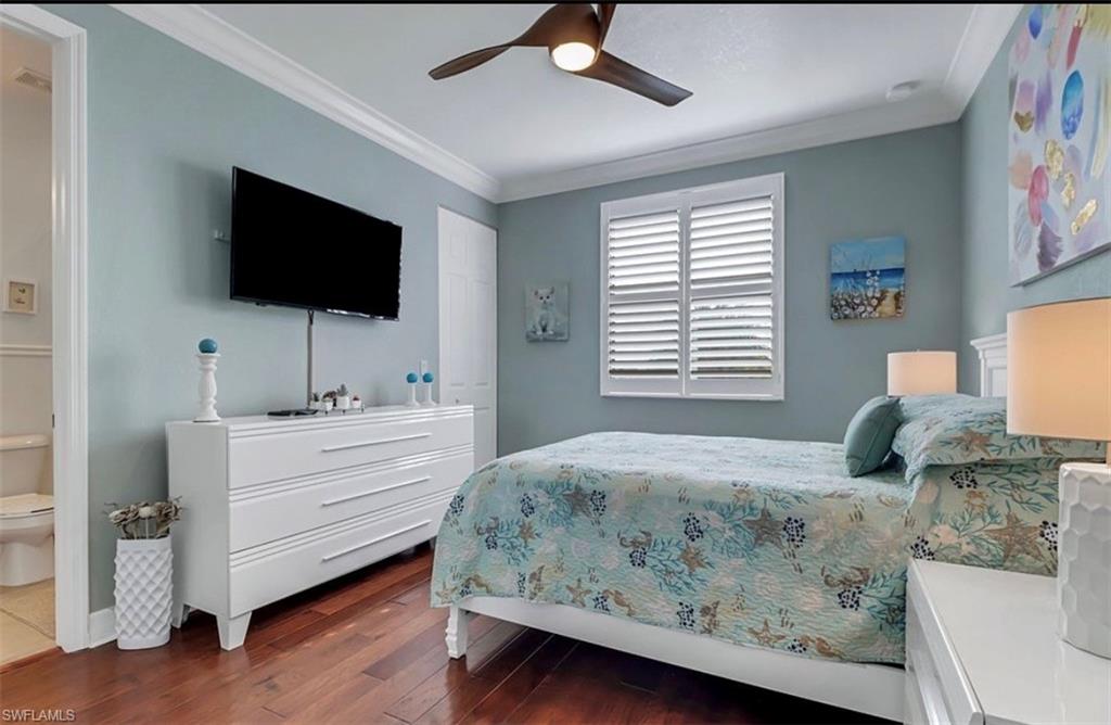 3402 Tigris Lane Naples, FL 34119 - Photo 30 of 50 a bedroom with a bed and a flat screen tv