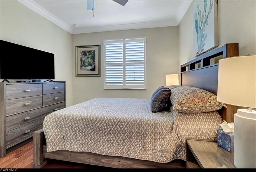3402 Tigris Lane Naples, FL 34119 - Photo 32 of 50 a bedroom with a bed and a flat tv screen on dresser