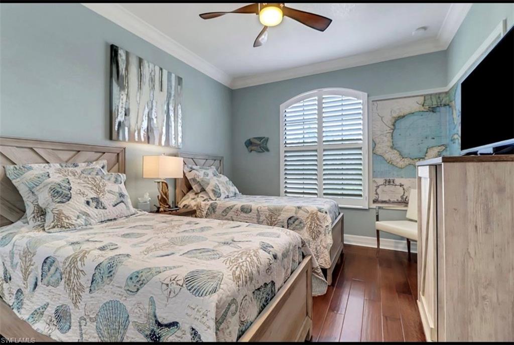 3402 Tigris Lane Naples, FL 34119 - Photo 34 of 50 a bedroom with a bed and a flat screen tv