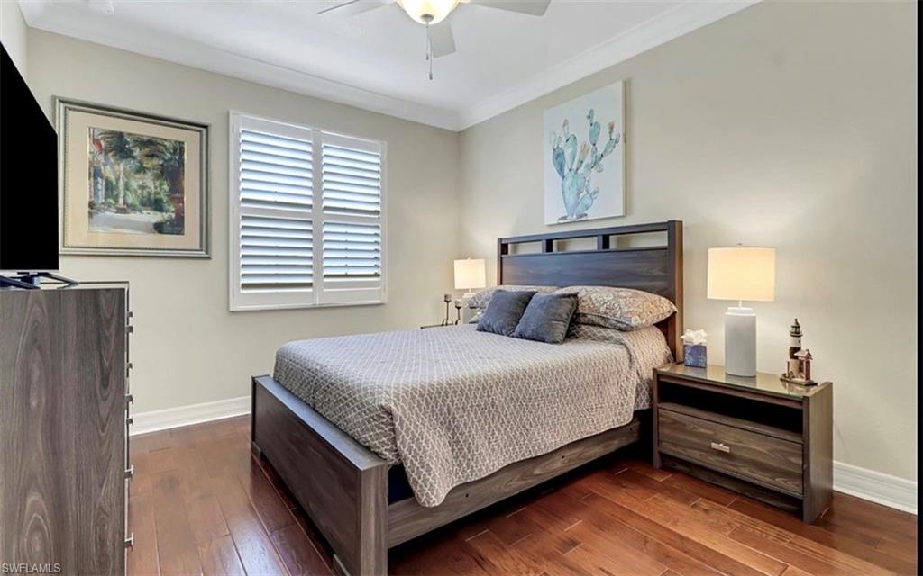 3402 Tigris Lane Naples, FL 34119 - Photo 35 of 50 a bed room with a bed and a night stand